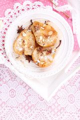 Baked pears with syrup on plate, on bright background