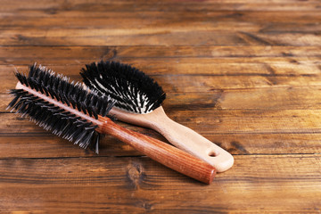 Wooden hairbrushes on wooden background
