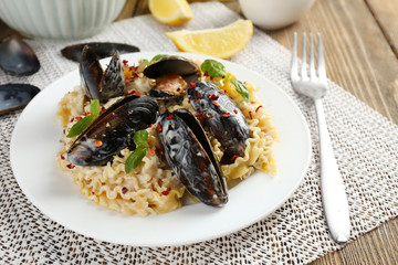 Traditional noodles with mussels on table, close up