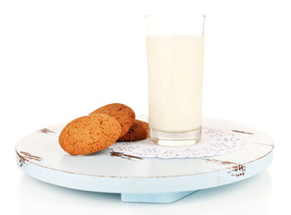 Milk and cookies on wooden tray isolated on white