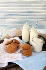 Milk and cookies on tray on table