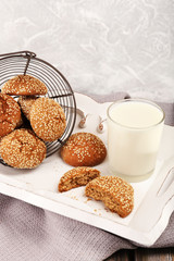 Milk and cookies on table on light grey background