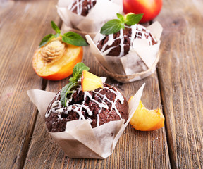 Tasty cupcakes with peach on table close-up
