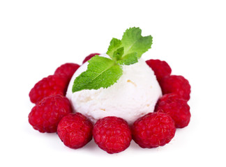 Creamy ice cream with raspberries and mint leaves isolated