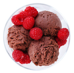 Chocolate ice cream with raspberries in glass bowl, isolated