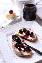 Fresh bread with cherry jam and homemade butter
