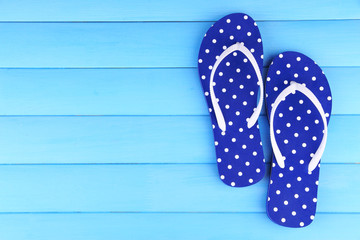 Color flip-flops on wooden background