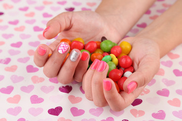 Female hand with stylish colorful nails holding colorful