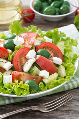 fresh green salad with vegetables and feta, vertical