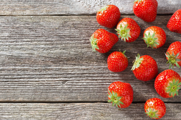 fresh strawberry on a wooden background, top view