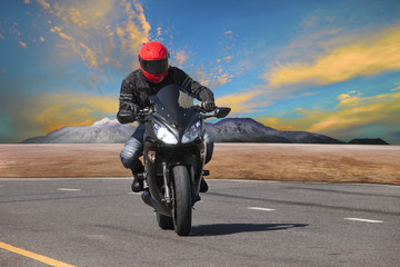 young man riding motorcycle in asphalt road curve use for extrem