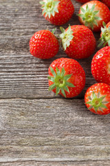 fresh strawberry on a wooden background, vertical