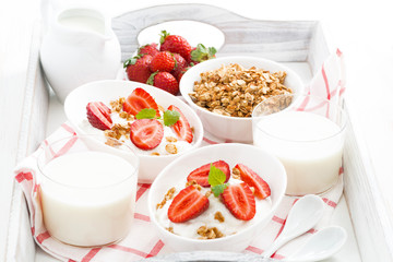 healthy breakfast - yogurt, strawberries, granola and milk