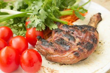 roasted duck on the grill with vegetables