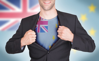 Businessman opening suit to reveal shirt with flag