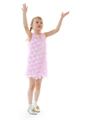 little girl tosses the ball