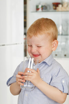 little boy drinks water