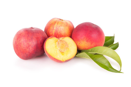 Group of fresh peaches with leaves