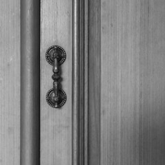 Ancient manor door handle on old wood door