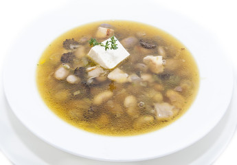 soup with beans and mushrooms garnished with goat cheese