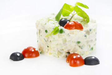 Olivier salad decorated with tomato