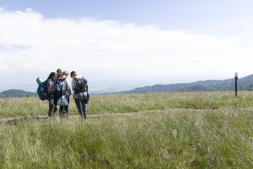 A group of friends on mountain path, Gorce Mountains, Poland