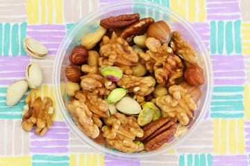 Mixed nuts in plastic box, close up
