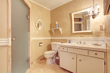 Fototapeta na wymiar Soft ivory empty bathroom interior in old house