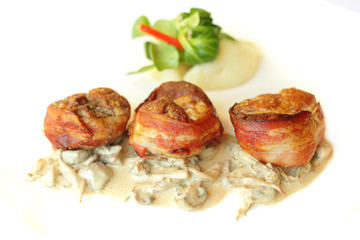 Meat in bacon with garnish, gourmet restaurant food