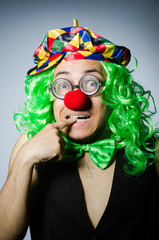 Funny clown against the dark background