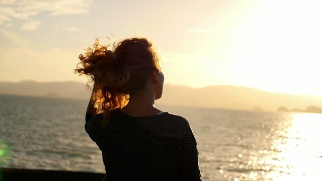 Lonely Woman Looking at the Sunset from the Ship. Slow Motion.