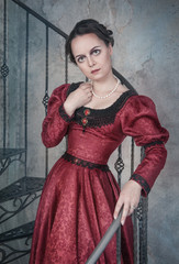 Beautiful woman in medieval dress on the stairway