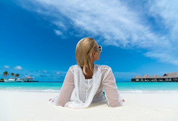 Fototapeta na wymiar Hot beautiful woman enjoying looking view of beach ocean