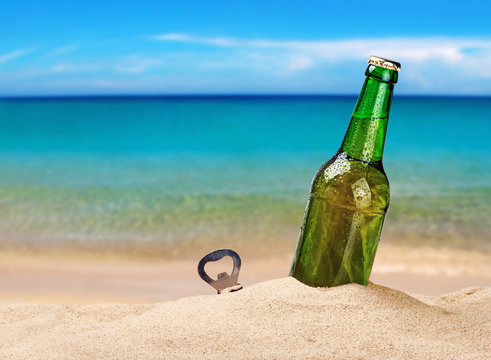 Beer bottle on a sandy beach