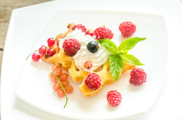 Belgian waffles with whipped cream and fresh berries