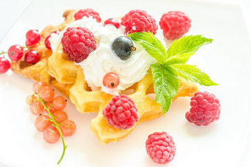Belgian waffles with whipped cream and fresh berries