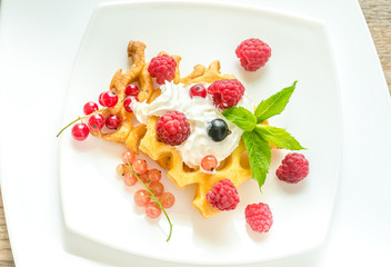Belgian waffles with whipped cream and fresh berries