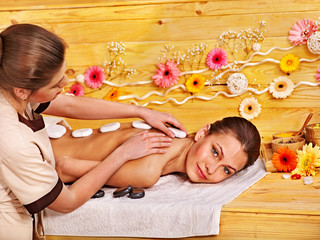 Obraz na płótnie Canvas Woman getting stone therapy massage .