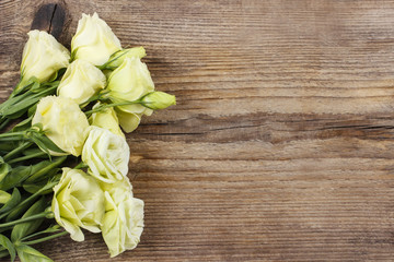 Bouquet of eustoma flowers on wooden table.