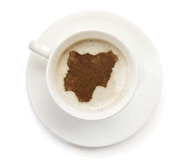 Cup of coffee with foam and powder in the shape of Nigeria.(seri