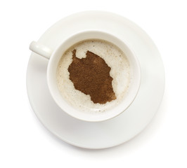 Cup of coffee with foam and powder in the shape of Tanzania.(ser