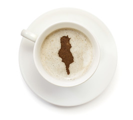 Cup of coffee with foam and powder in the shape of Tunisia.(seri