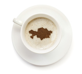 Obraz premium Cup of coffee with foam and powder in the shape of Kazakhstan.(s
