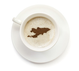 Cup of coffee with foam and powder in the shape of Kyrgyzstan.(s