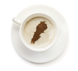 Cup of coffee with foam and powder in the shape of Lebanon.(seri