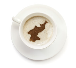 Cup of coffee with foam and powder in the shape of North Korea.(