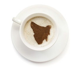 Cup of coffee with foam and powder in the shape of Tasmania.(ser