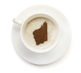 Cup of coffee with foam and powder in the shape of Western Austr