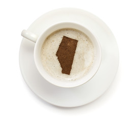 Cup of coffee with foam and powder in the shape of Alberta.(seri