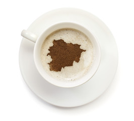 Cup of coffee with foam and powder in the shape of Andorra.(seri